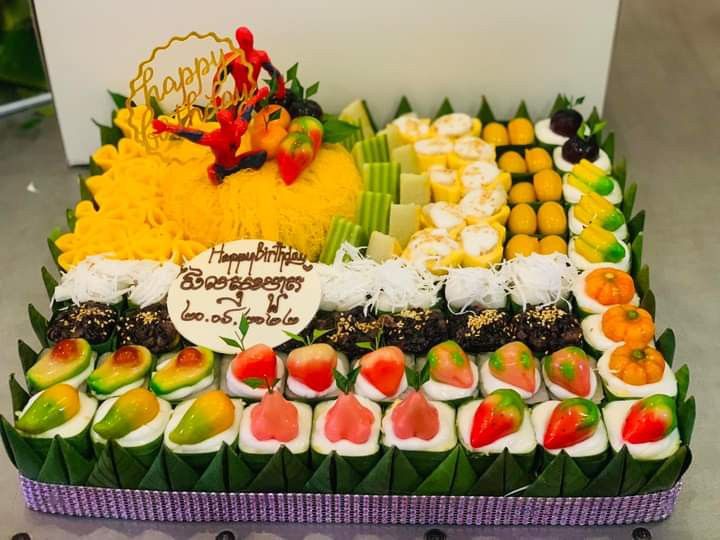 an assortment of fruit is displayed in a box on the table for people to eat