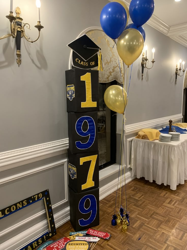 balloons and streamers are on the floor in front of a sign that says graduation