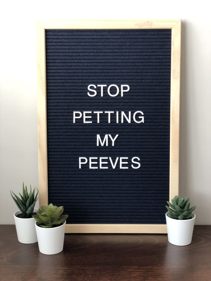 a sign that says stop petting my peeves next to some succulents