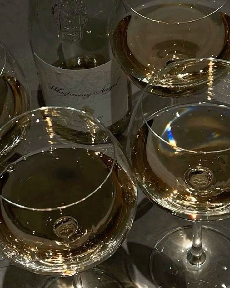 several wine glasses are sitting next to each other