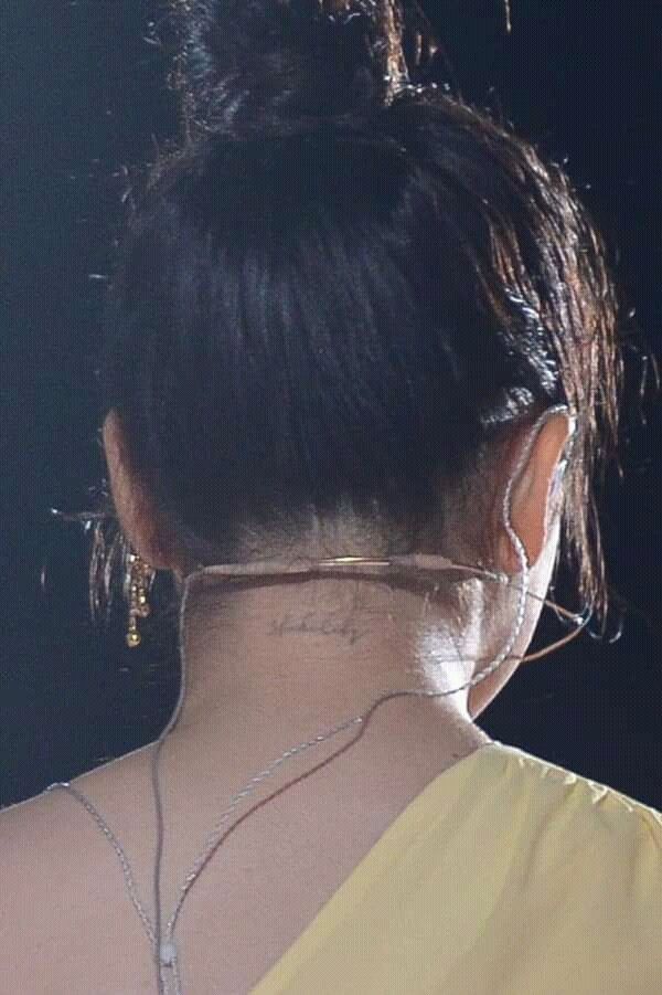 the back of a woman's head with ear rings and necklaces on it