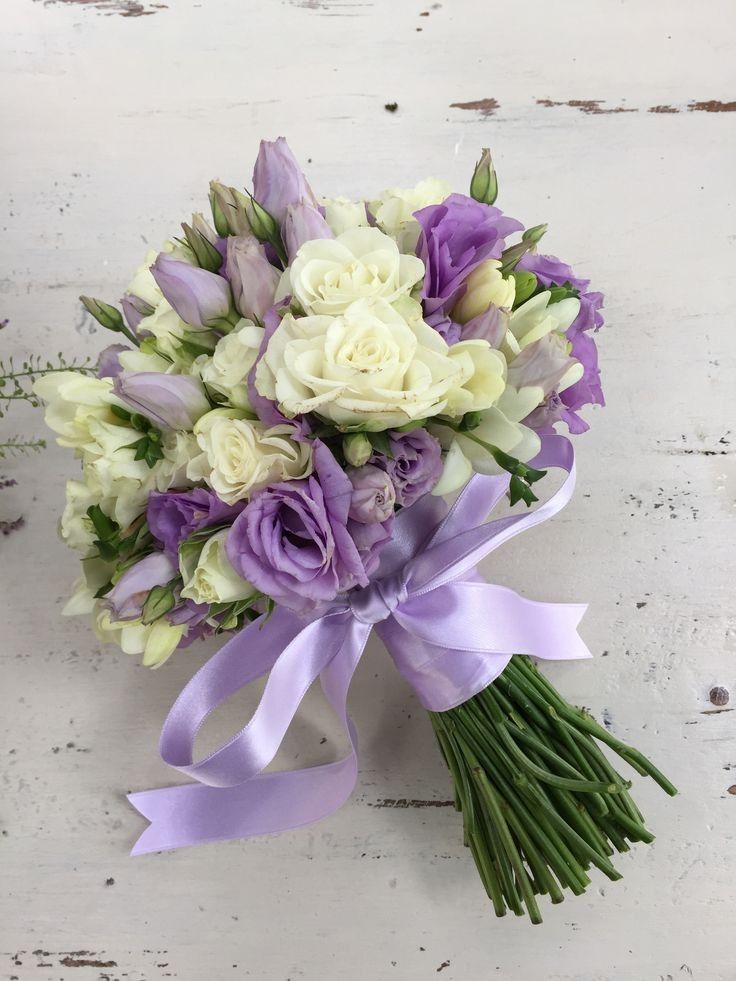 a bridal bouquet with purple and white flowers