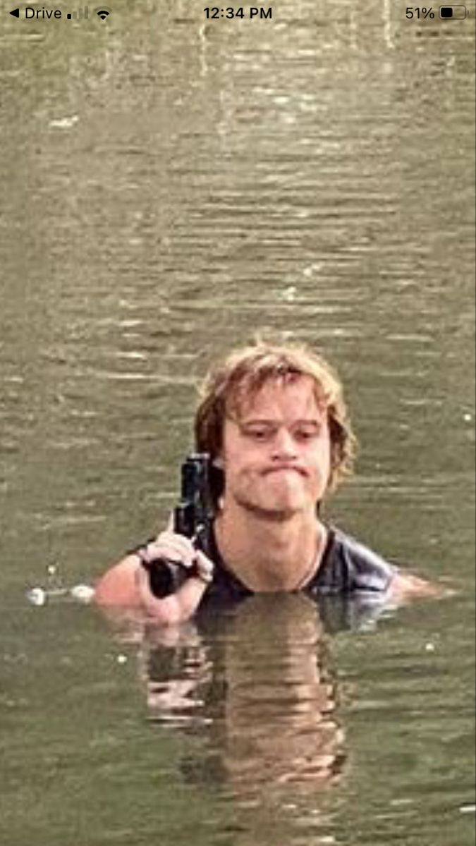 a man holding a camera in the water