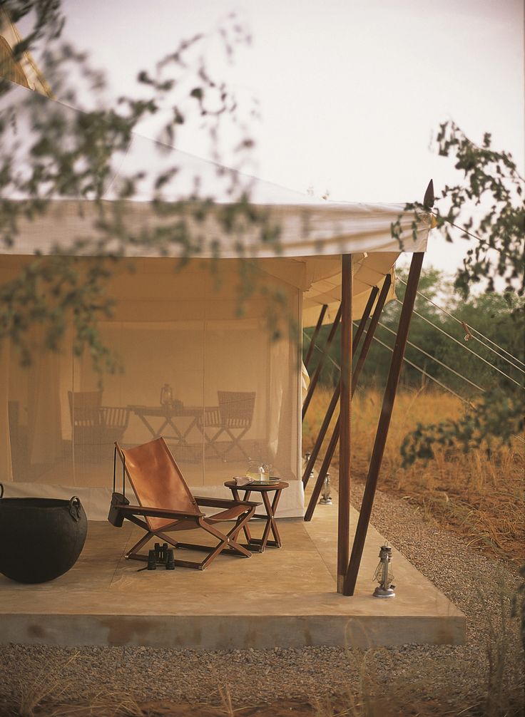 an outdoor area with chairs, table and fire pit