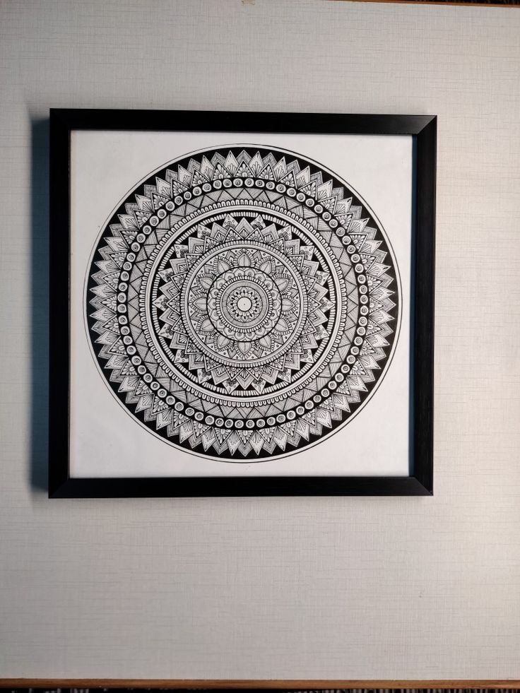 a black and white artwork hanging on the wall