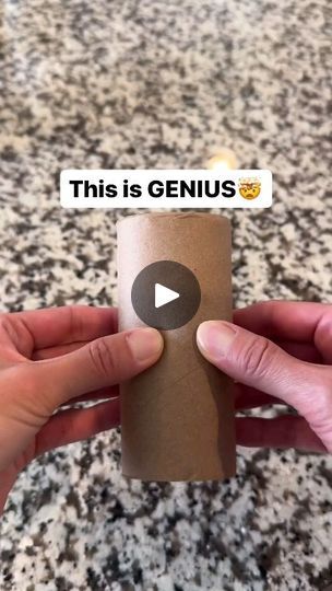 someone holding up a roll of toilet paper with the word genius on it in front of them