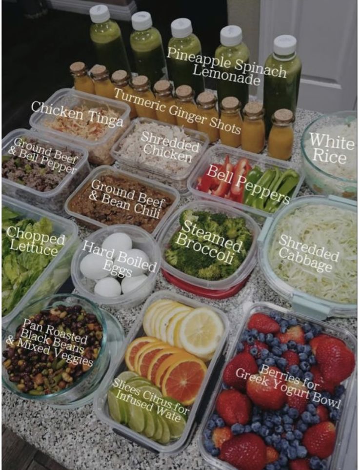 a table topped with plastic containers filled with different types of food and condiments