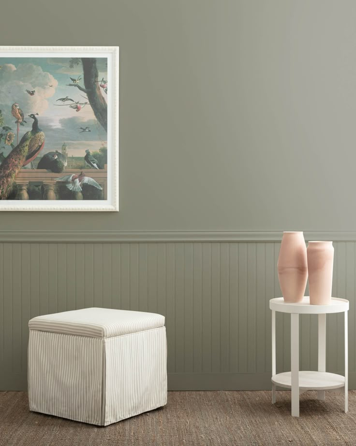 two vases sitting next to each other in front of a painting on the wall