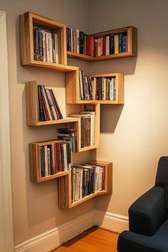 a room with a chair, bookshelf and wall mounted shelves on the wall