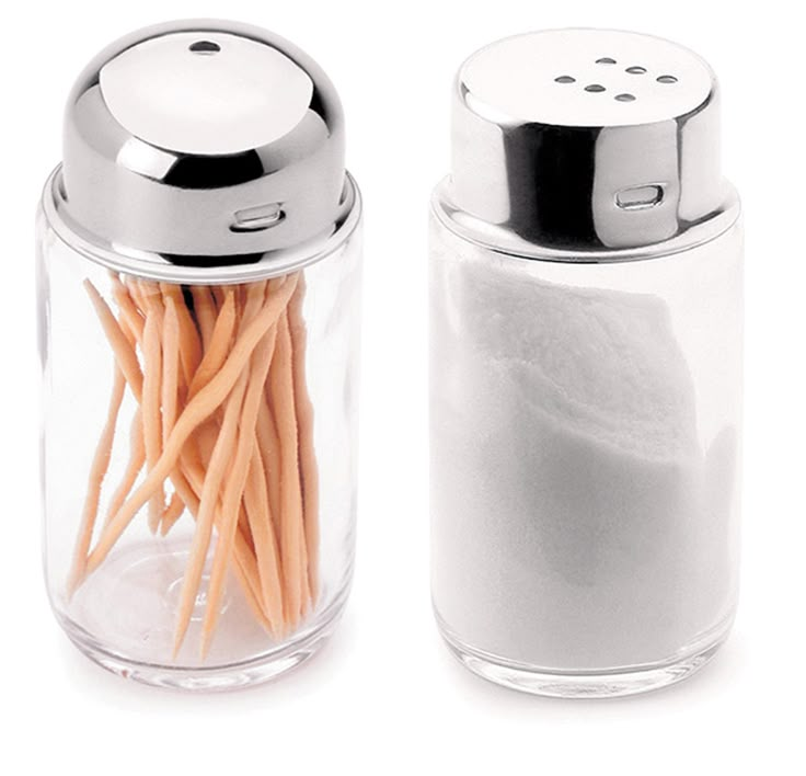 two salt and pepper shakers sitting next to each other