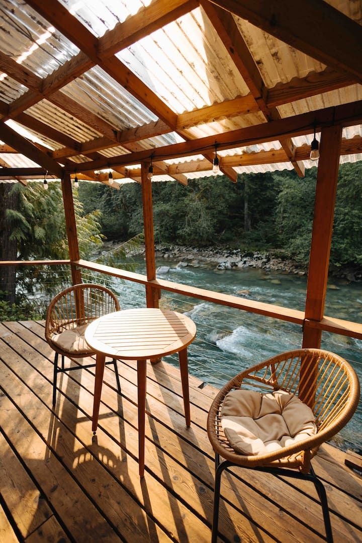 two chairs and a table on a wooden deck