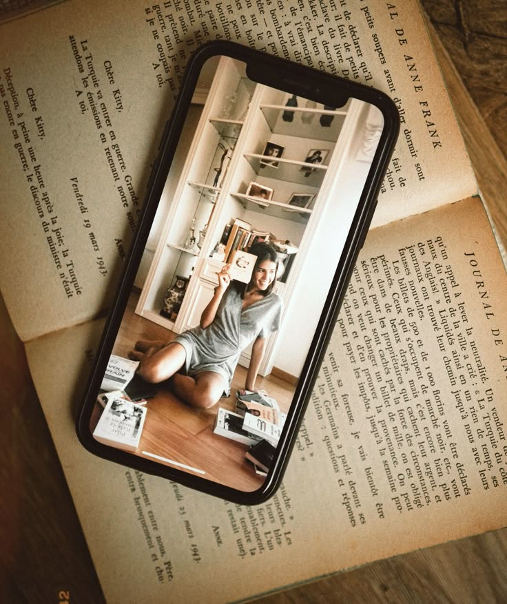 a cell phone case sitting on top of an open book with a photo of a man