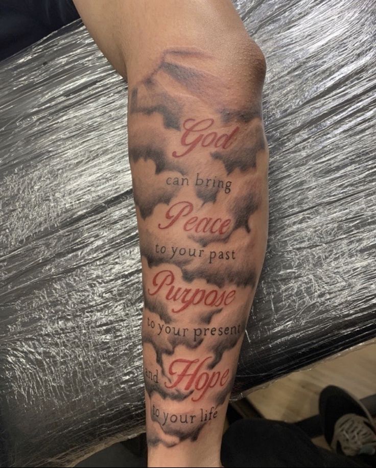 a man's leg with clouds and bible verse on it, which reads god can bring peace to your past