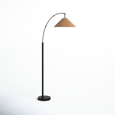 a black floor lamp with a beige shade