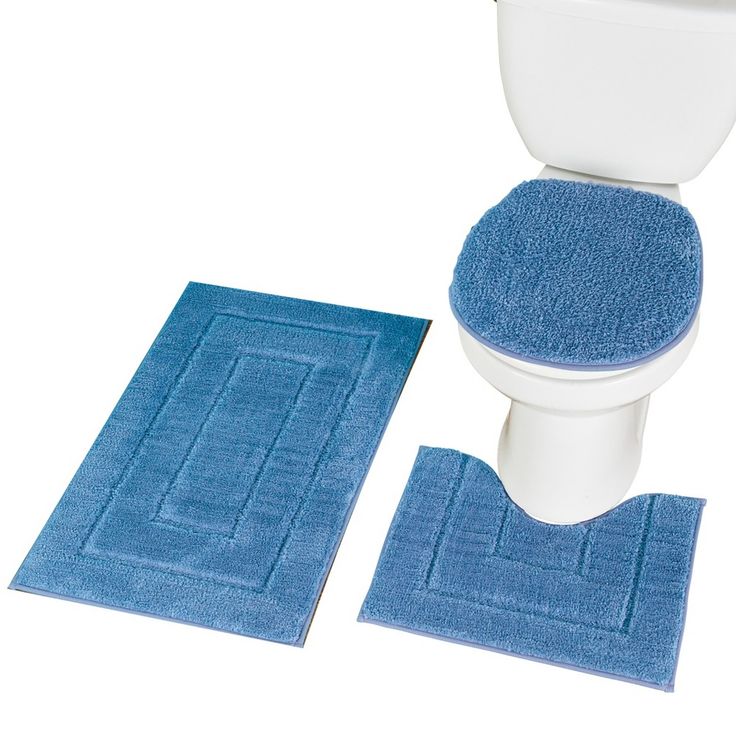 a toilet with two blue rugs next to it