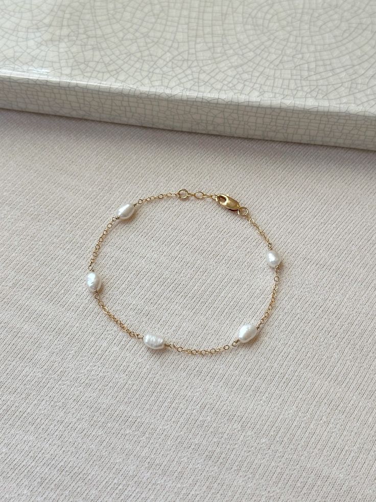 Please review the bracelet sizing guide below for the perfect fit! This dainty natural Pearl bracelet looks perfect for special occasions or can elevate any casual outfit. Each Pearl is hand wrapped skin friendly 14K Gold Filled or 925 Sterling Silver. Every bracelet comes with a small extender for adjustable sizing. You will feel sophisticated and chic when you put it on! Pair it with the Gianna Pearl Earrings or Isla Pearl bracelet for a lovely matching set! * 6-7mm freshwater Pearls * Pearl s Pearl Bracelet Designs, Bridal Pearl Bracelet, Pearl Gold Bracelet, Wedding Jewelry Bride, Dainty Pearl Bracelet, Bridal Bracelet Pearl, Jewelry Bride, Pearl Bracelet Gold, Freshwater Pearl Jewelry