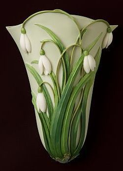 a glass vase with white flowers and green stems