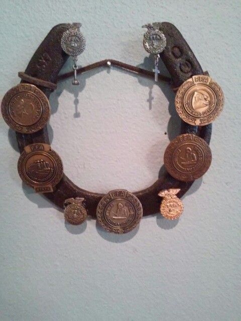 a bracelet made out of old coins on a wall