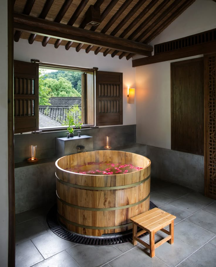 a large wooden tub sitting inside of a bathroom