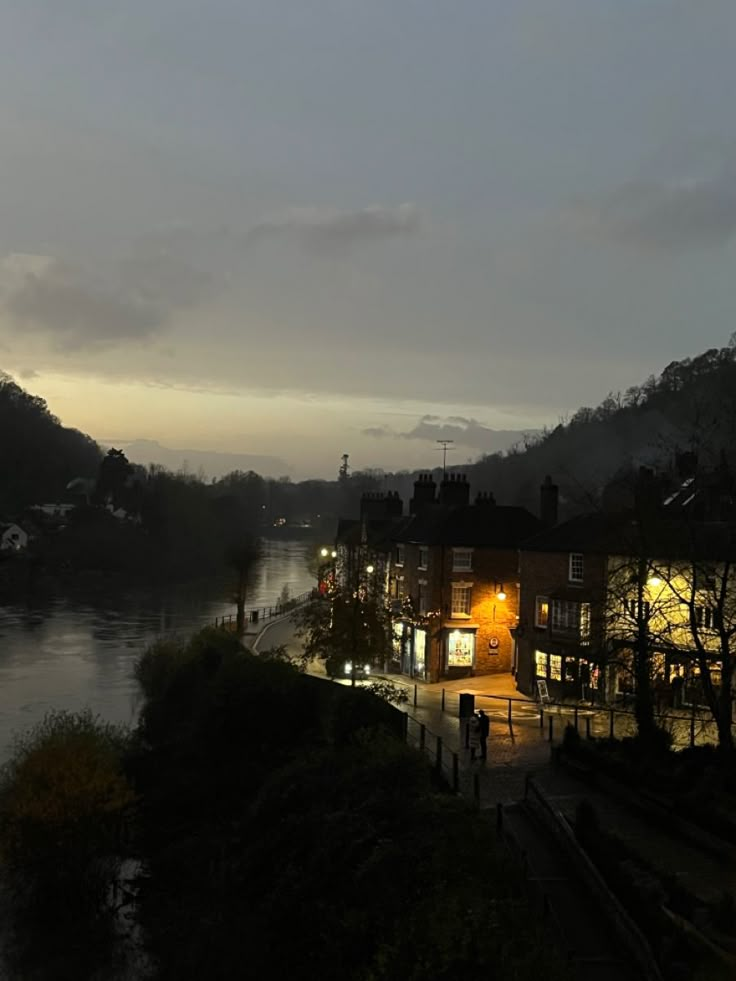 a city street next to a river at night