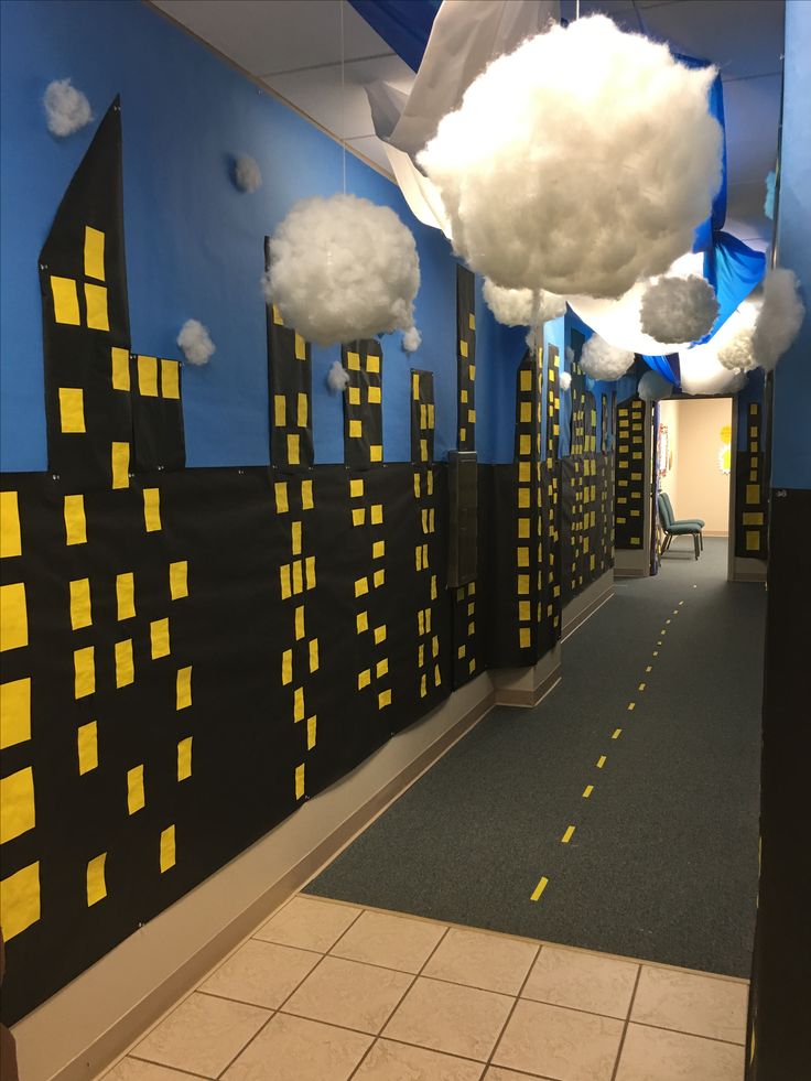 a hallway decorated with yellow and black paper clouds