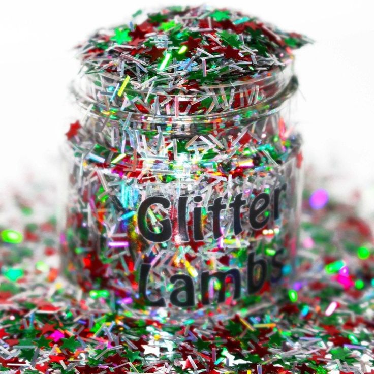 a jar filled with confetti sitting on top of a pile of confetti