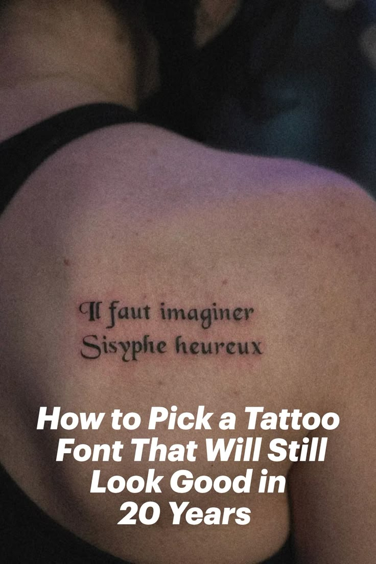 Gabby Pignanelli posing with her back to the camera showing off her tattoo that states, "If fault imaginer sysphe heureux." Where To Put Writing Tattoos, Tattoo Word Ideas Female, Unique Lettering Tattoo, Old English Text Tattoo, Writing Styles For Tattoos, Best Font For Tattoo Lettering, Classic Tattoo Lettering, Old Script Tattoo, Block Letter Tattoo Fonts