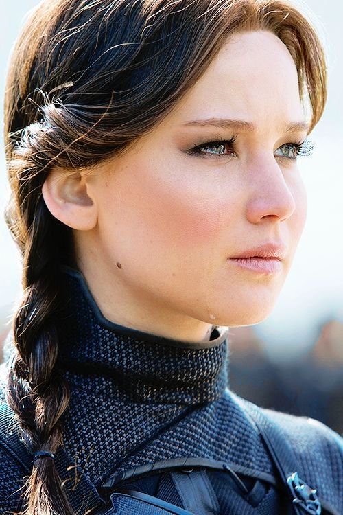 a close up of a person with a braid in her hair