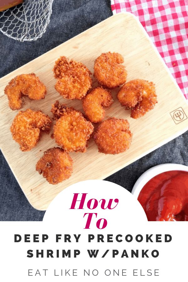 deep fry fried shrimp with ketchup on a cutting board next to a bowl of sauce