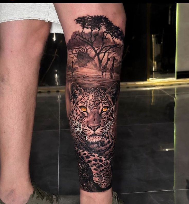 a man with a tattoo on his leg has a leopard and trees in the background