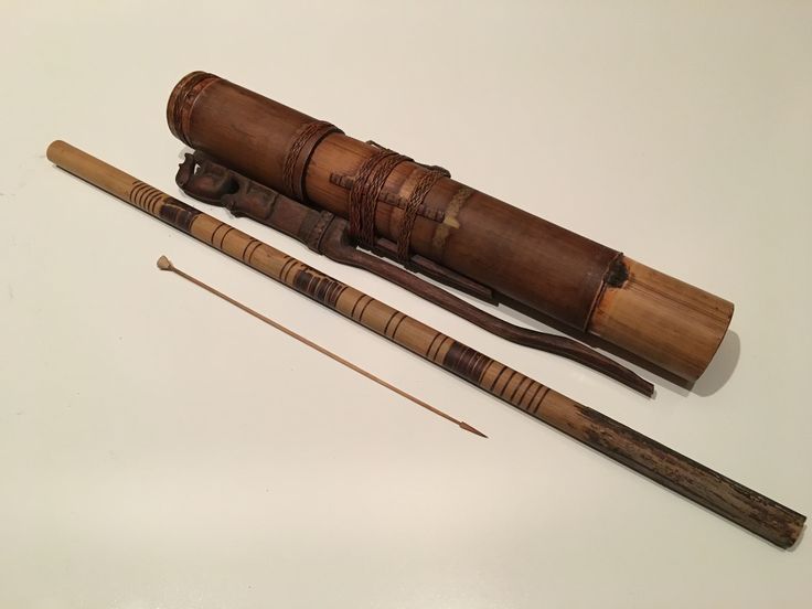 two old fashioned wooden items on a white surface with one long stick and the other small piece of wood