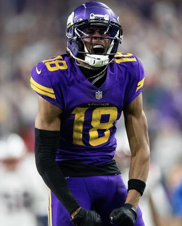 a close up of a football player wearing a uniform