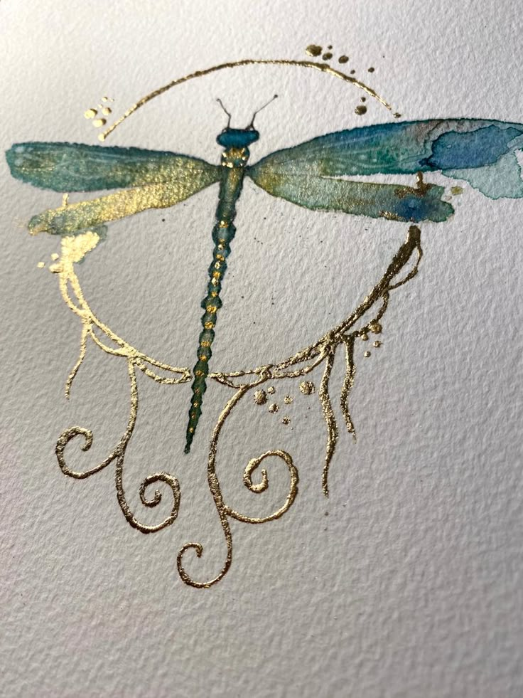 a drawing of a blue dragonfly sitting on top of a piece of white paper