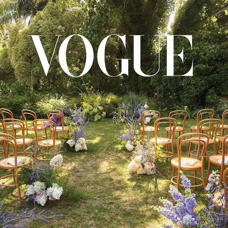 an outdoor ceremony setup with chairs and flowers on the lawn, surrounded by greenery