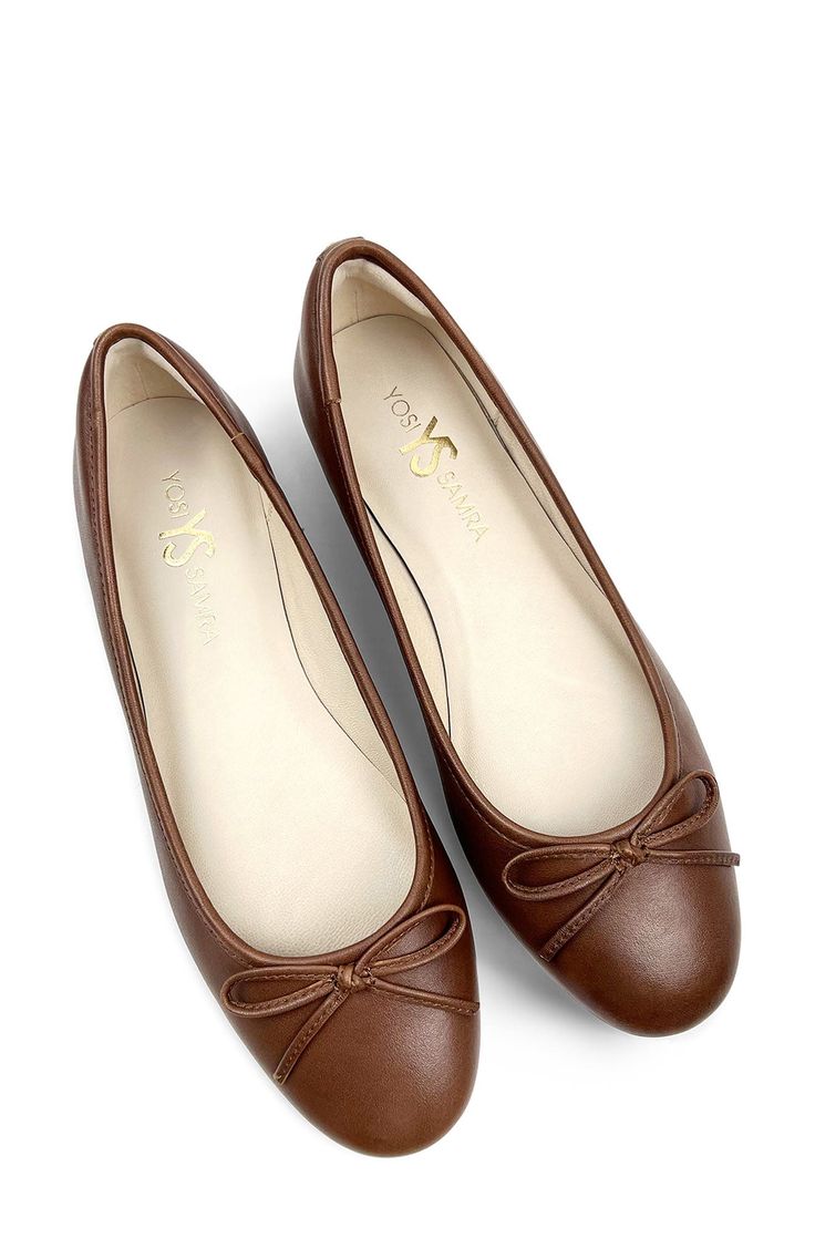 Signature logo hardware and a delicate vamp bow lend luxe elements to a timeless ballet flat set on a cushioned footbed for lasting comfort. Memory foam cushioning with arch support Slip-resistant sole Leather upper and lining/rubber sole Imported Elegant Slip-on Ballet Flats With Arch Support, Elegant Brown Ballet Flats With Removable Insole, Elegant Ballet Flats With Arch Support, Classic Brown Ballet Flats, Elegant Brown Flats With Bow, Elegant Ballet Flats With Cushioned Footbed And Round Toe, Elegant Cushioned Closed Toe Ballet Flats, Elegant Closed Toe Ballet Flats With Cushioned Footbed, Elegant Flats With Arch Support And Round Toe