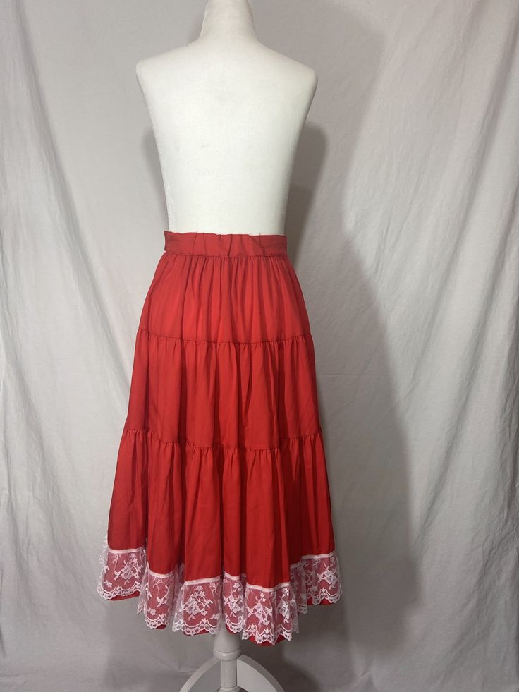 1970s Rockmount Ranch Wear tiered full circle skirt with side button closure, elastic panel in back waistline, and white lace trim at hem.Waist: 26-28”Hips: freeLength: 26” Ranch Wear, Full Circle Skirt, Full Circle Skirts, Full Circle, Circle Skirt, Skater Skirt, White Lace, Lace Trim, 1970s