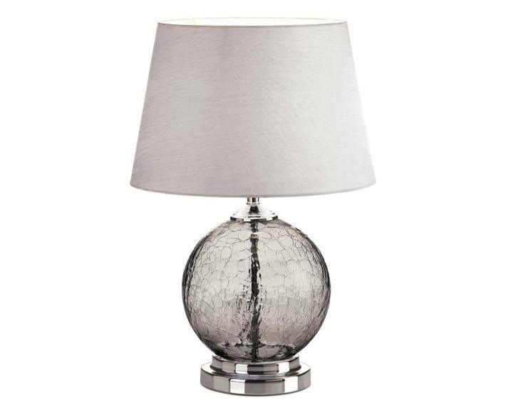 a glass table lamp with a white shade on the base and a silver metal base