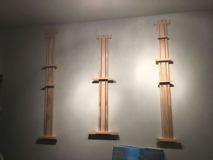 three wooden poles are hanging on the wall