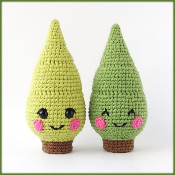 two crocheted green and pink pears sitting next to each other