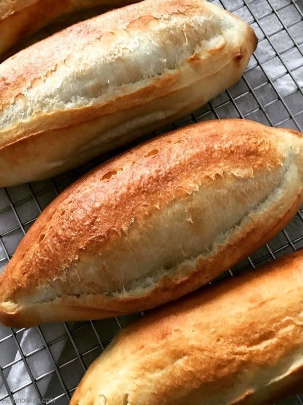 three loaves of bread sitting on top of a cooling rack