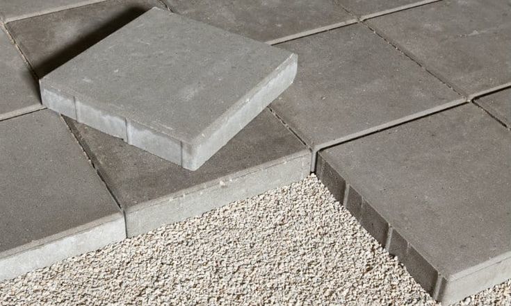 two concrete blocks laying on top of each other in the middle of gravel and rocks