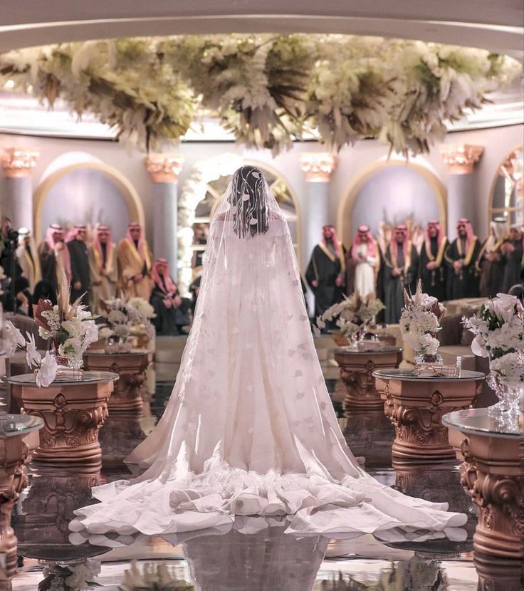 a wedding dress is displayed in front of an audience