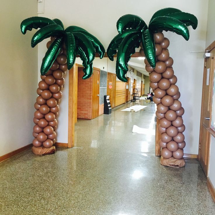 two palm trees made out of balloons in the hallway