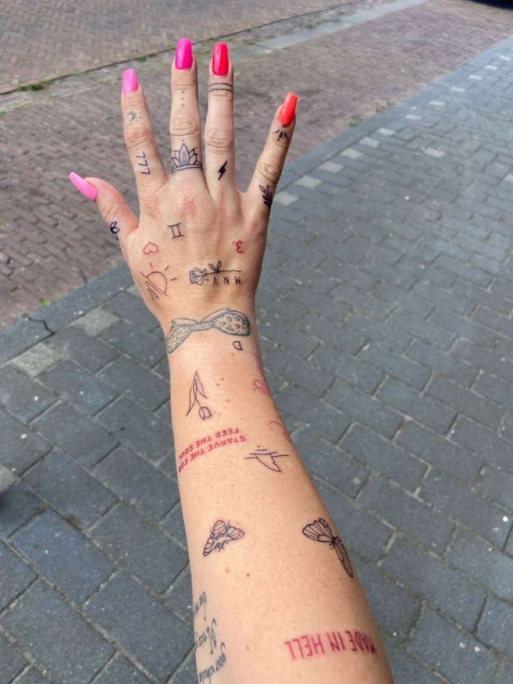 a woman's hand with tattoos on it