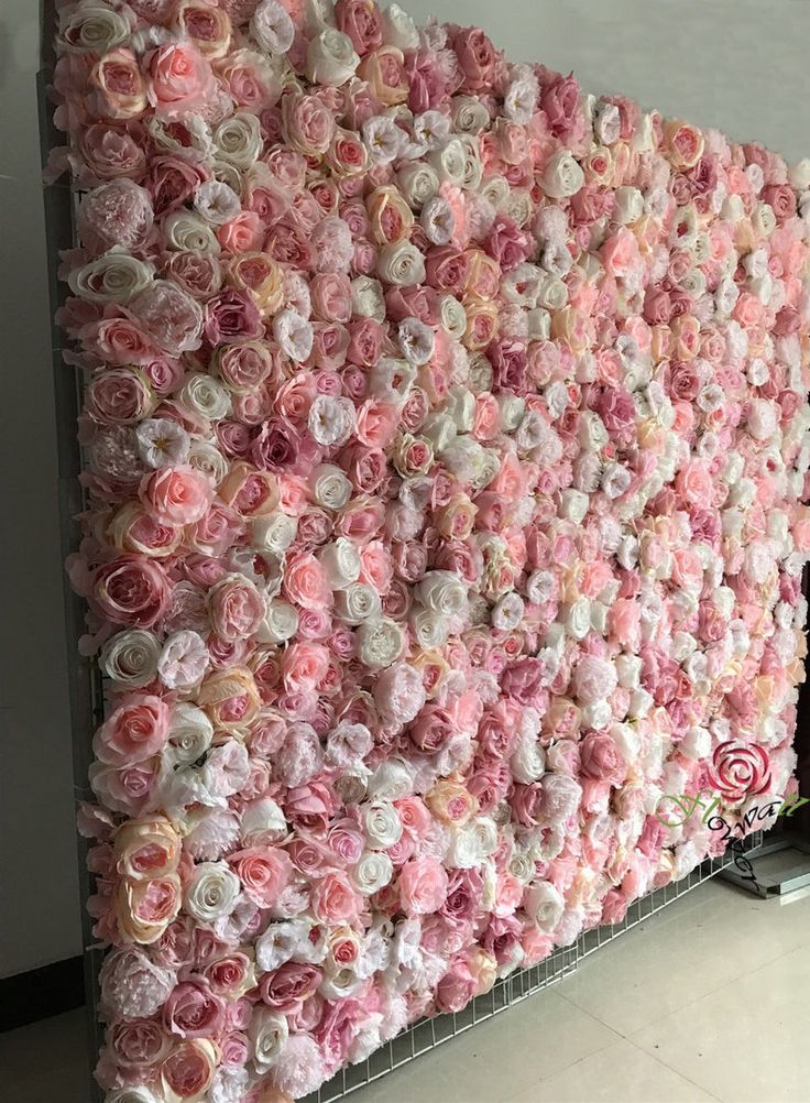 a wall made out of pink and white flowers