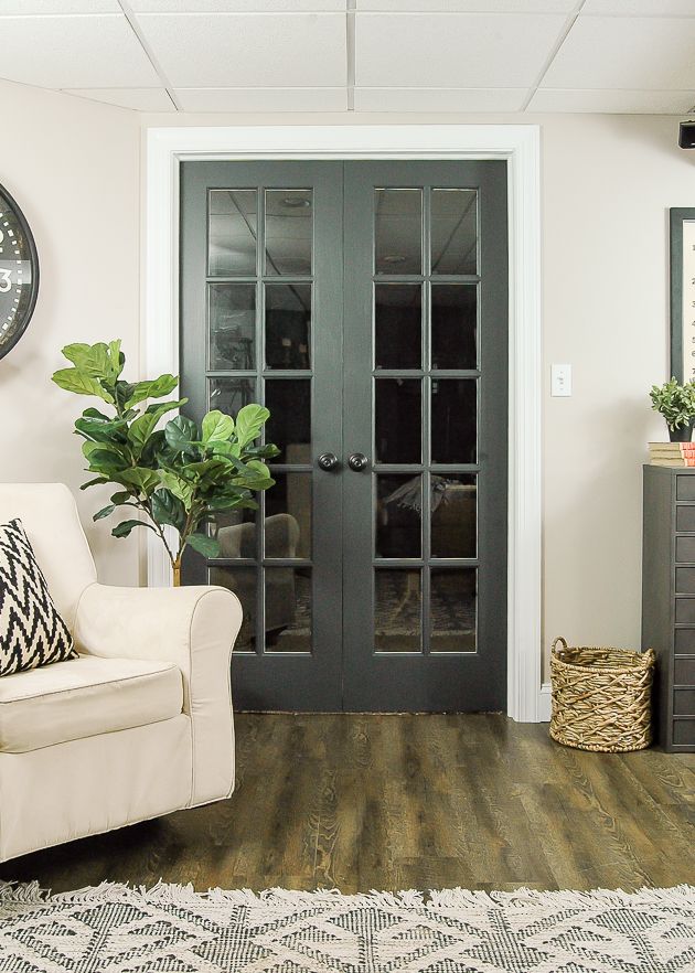 a living room with wooden floors and doors