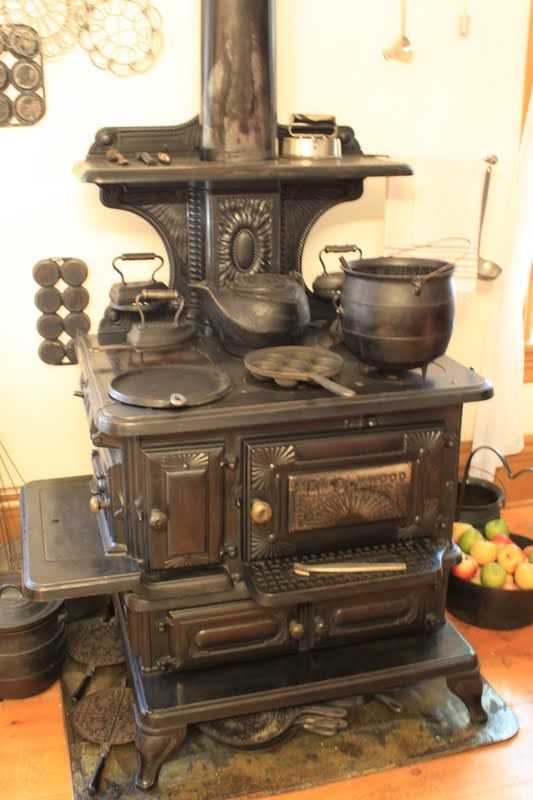 an old fashioned stove with pots and pans on it