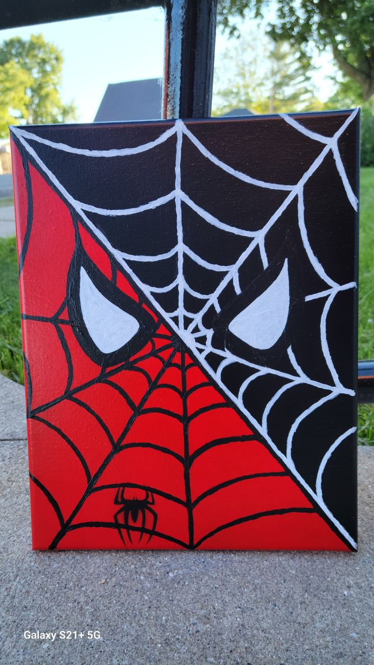 a spider - man face painted on the side of a building