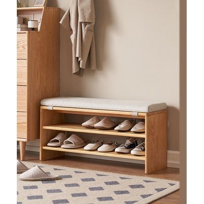 a wooden shoe rack with shoes on it