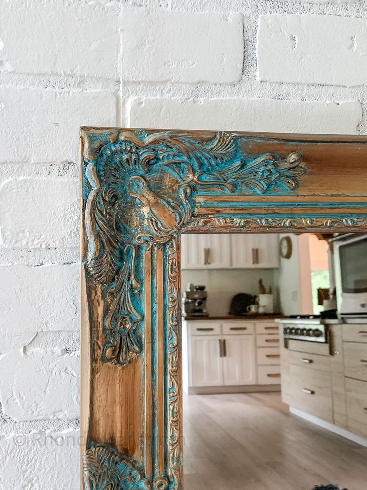 a mirror that is on top of a wooden floor in front of a brick wall